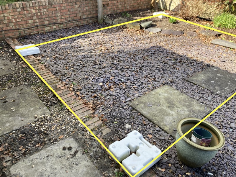The site. The yellow lines indicate the extent of a 4.5 m x 3.5 m office. Slate on soil.