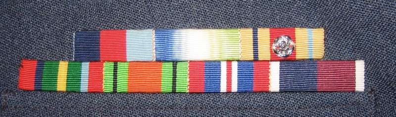 Ribbon medals: Top row: 1939-1945 Star, Atlantic Star, Africa Star (with North Africa 1942-43 clasp, for Navy service).
Second row: Pacific Star, Defence Medal, War Medal 1939–1945, RAF Long Service and Good Conduct.